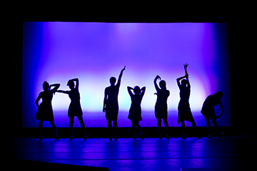 Dancers on stage. Links to What to Give